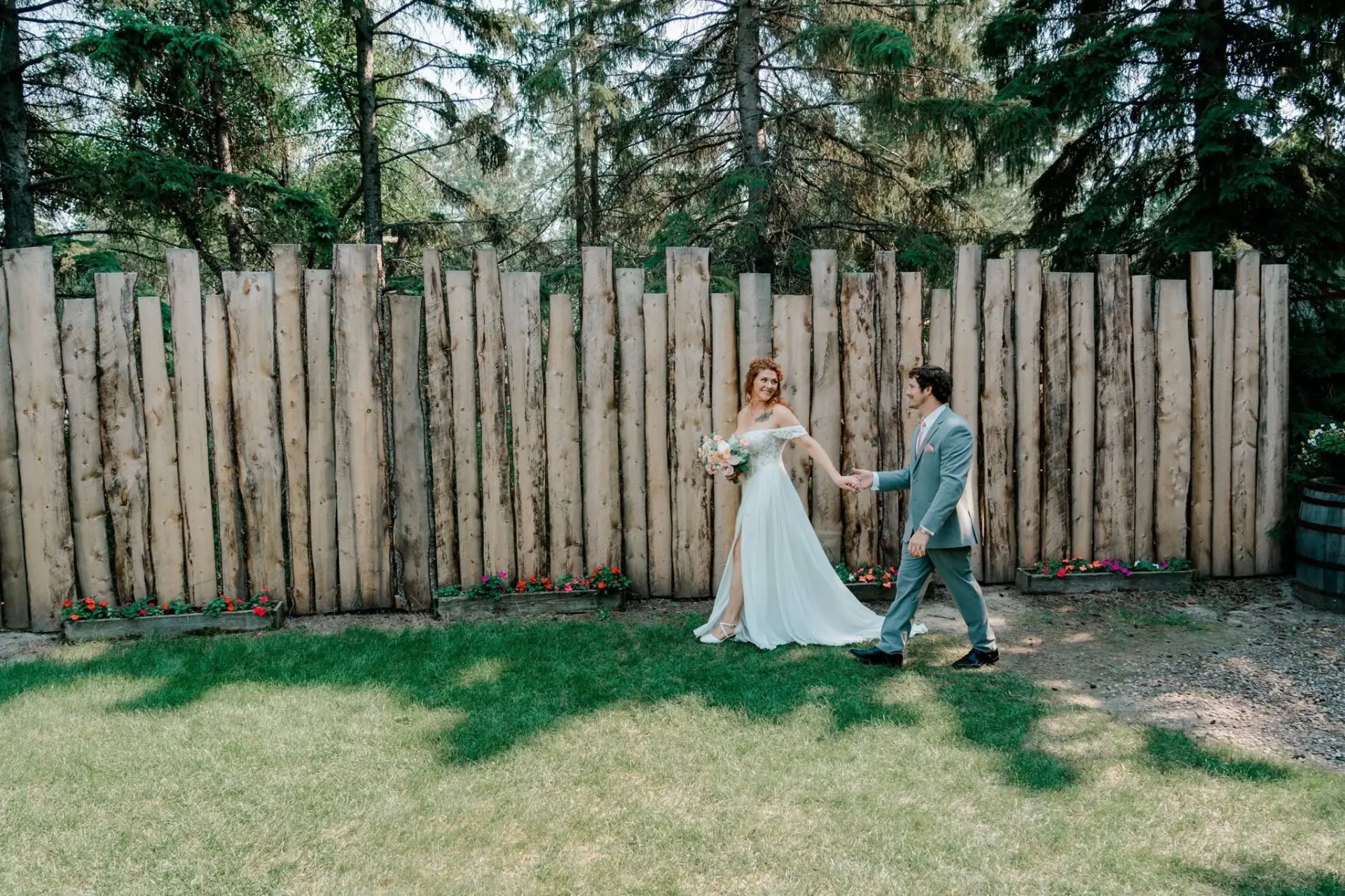 Couple walking along the timber fence
