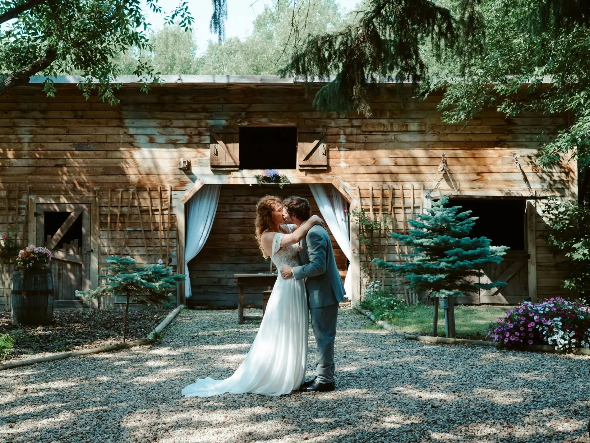 Newlyweds kissing at the barn